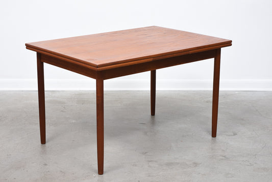 Extending rectangular dining table in teak