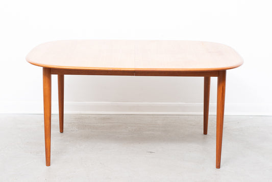 Extending oval dining table in teak