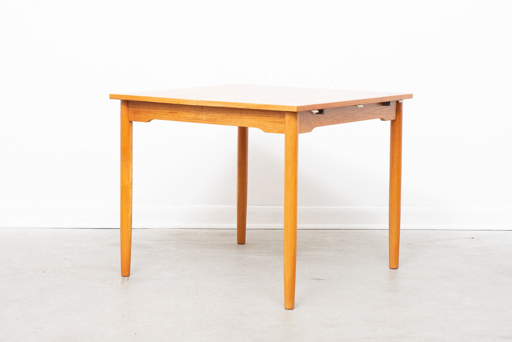 Extending square dining table in teak