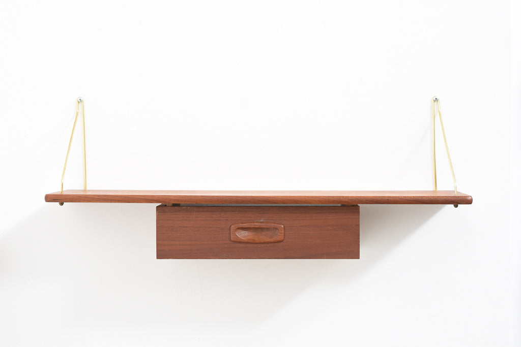 Floating shelf in teak with brass supports