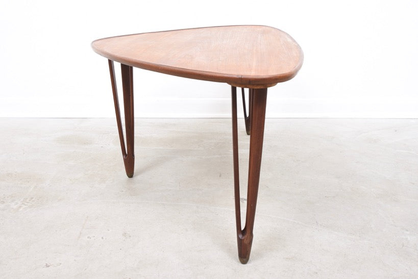 Triangular coffee table with intricate tripod legs