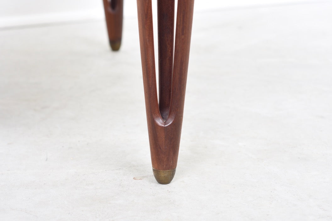 Triangular coffee table with intricate tripod legs