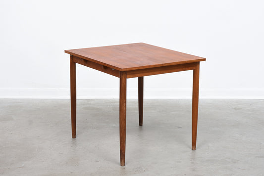 Extending square dining table in teak