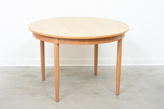 Round extending dining table in oak