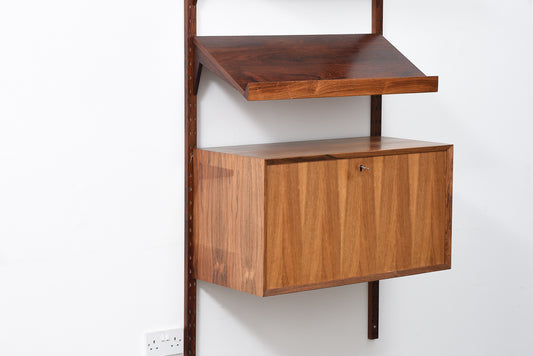 Single bay of rosewood shelving by CADO