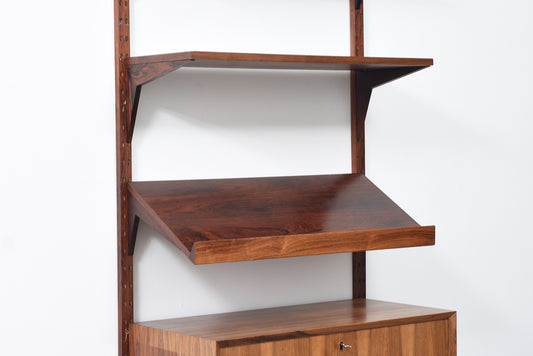 Single bay of rosewood shelving by CADO