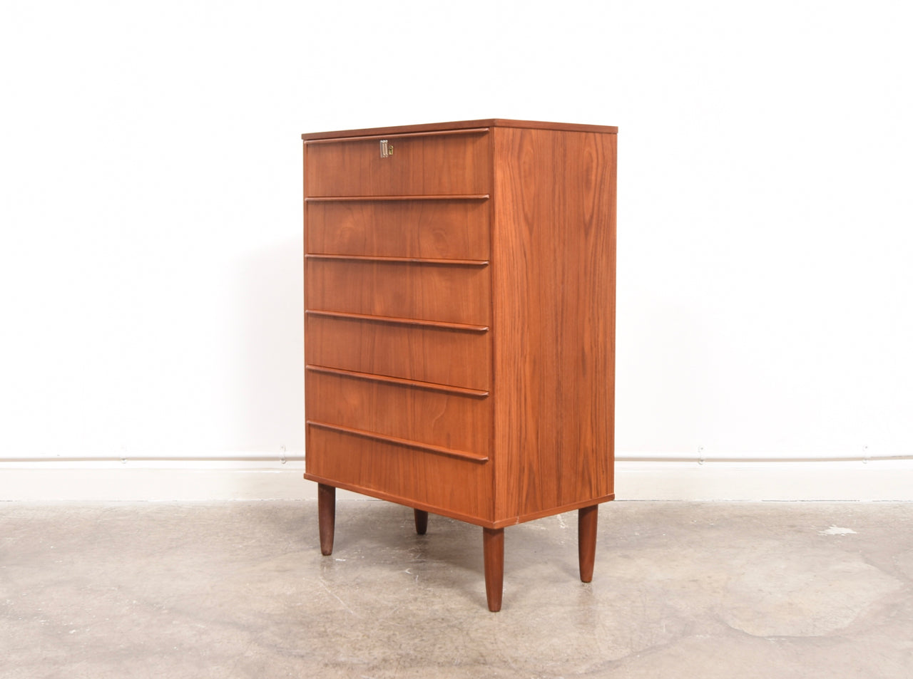 Chest of six teak drawers with lipped handles