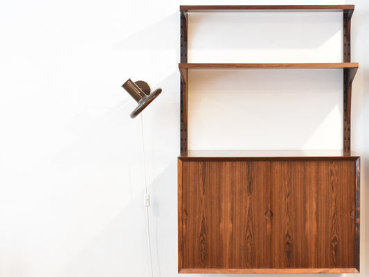 Single bay of rosewood shelving by CADO