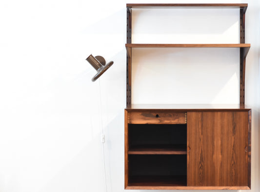 Single bay of rosewood shelving by CADO