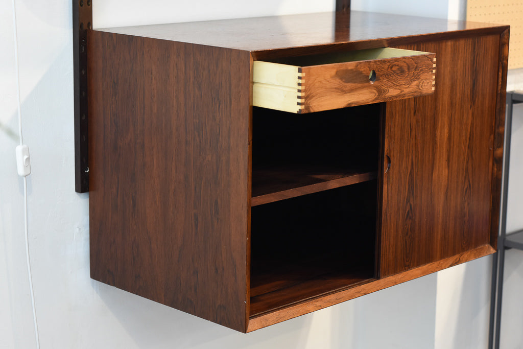 Single bay of rosewood shelving by CADO