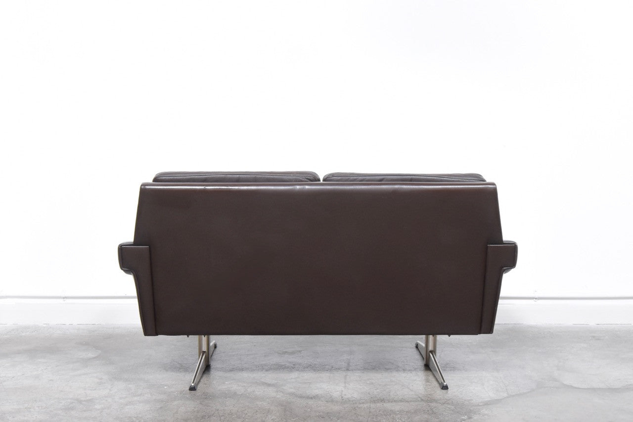 Two seat sofa in leather on shaker legs