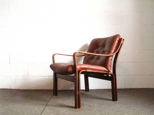 Low back lounge chair with tan leather cushions