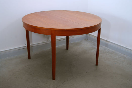 Round extending dining table in teak