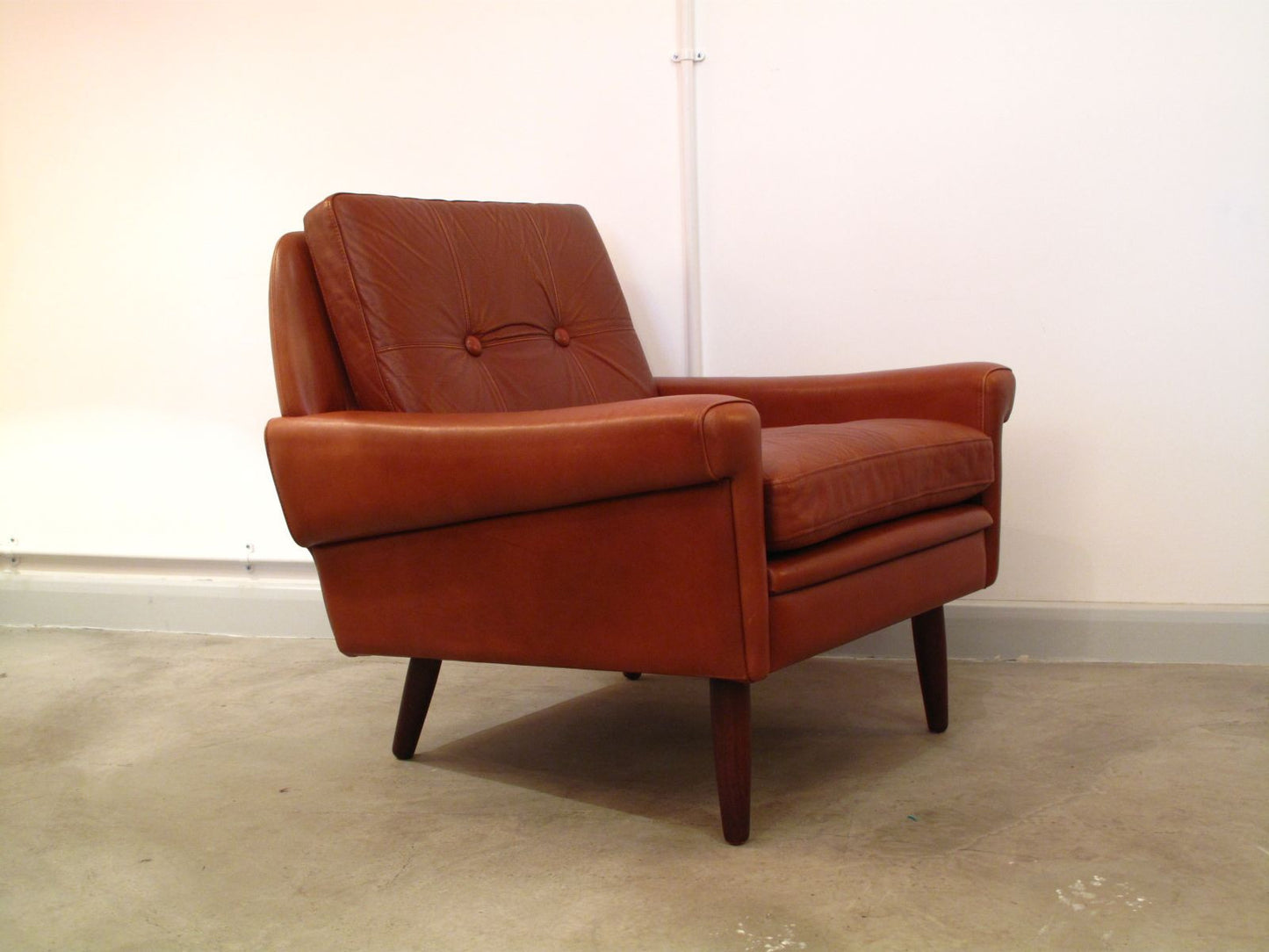 Lowback caramel-colored lounge chair