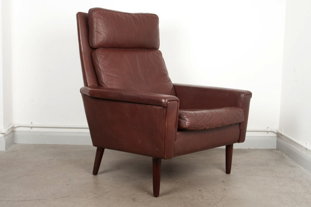 High back leather lounge chair on oak legs