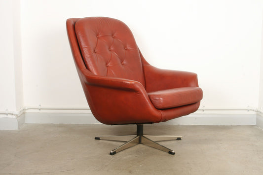 Leather bucket chair on swivel base