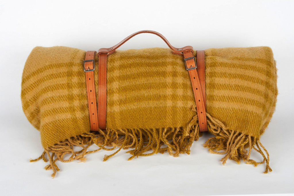 Wool blanket with leather strap carrier