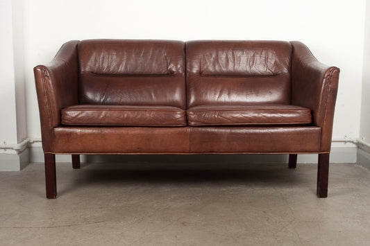 Two seat brown leather sofa