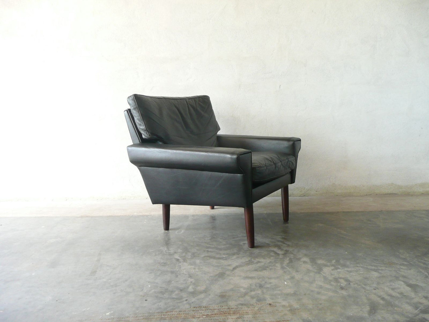 Lowback black leather lounge chair