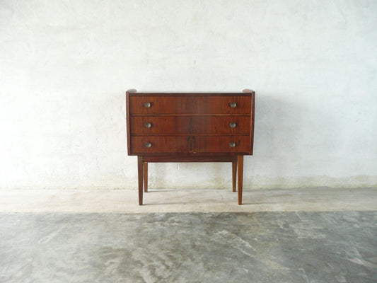 Short chest of three drawers in rosewood