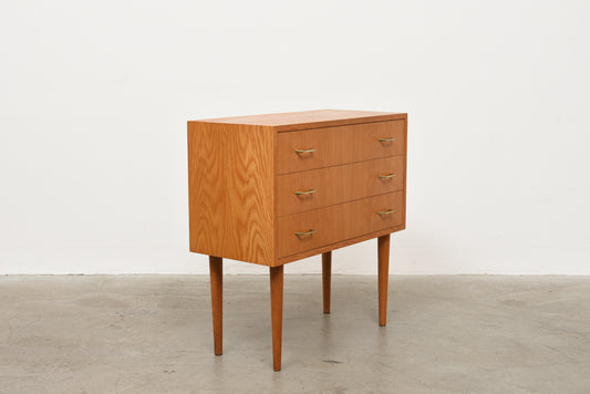 Low oak chest with brass handles