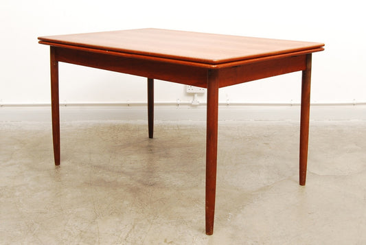 Extending rectangular dining table in teak