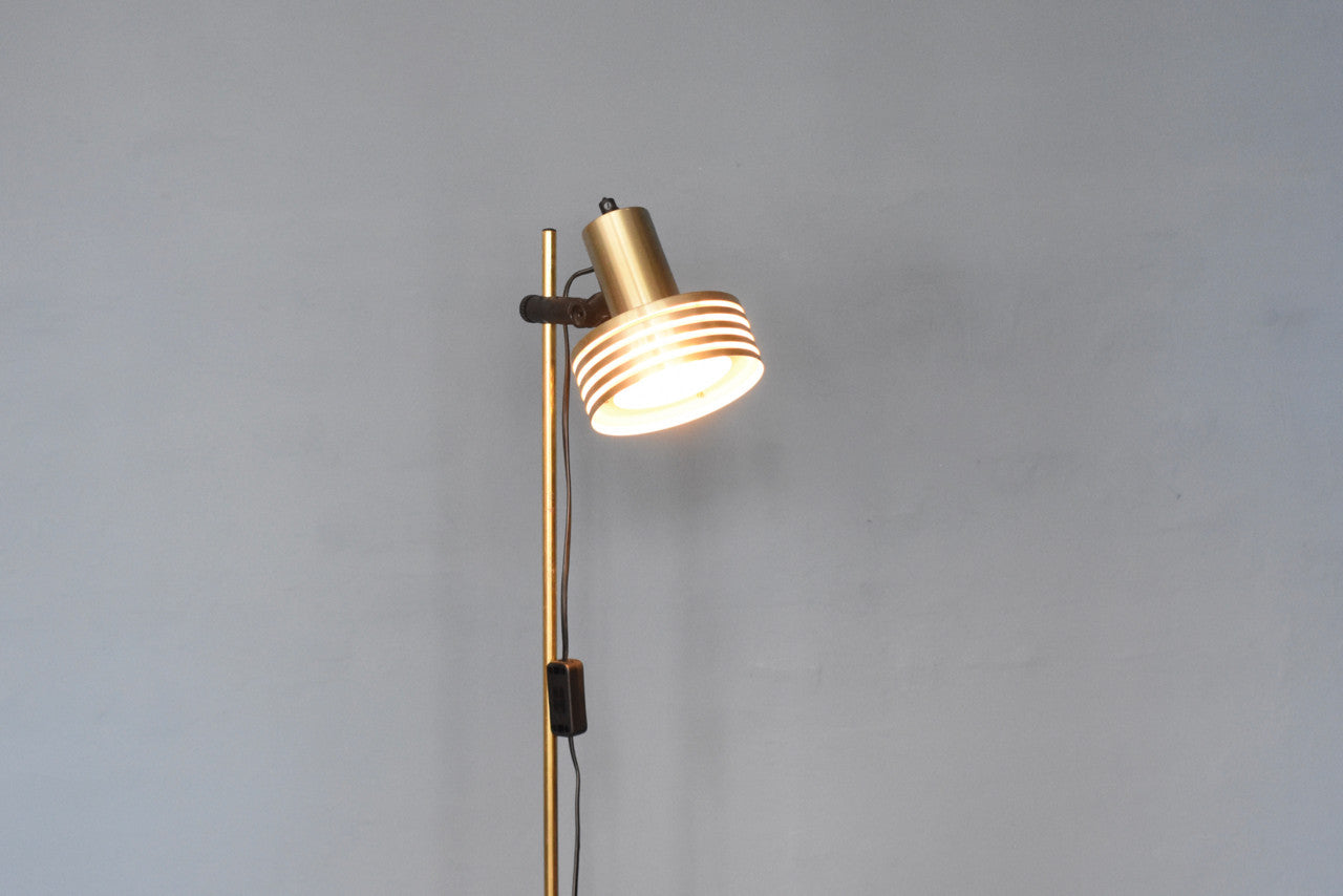 Brass floor light with multi-tiered shade