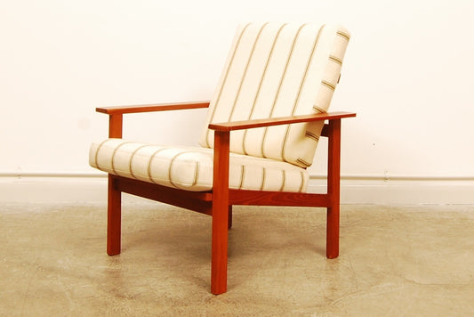 Teak lounge chair with cream cushions