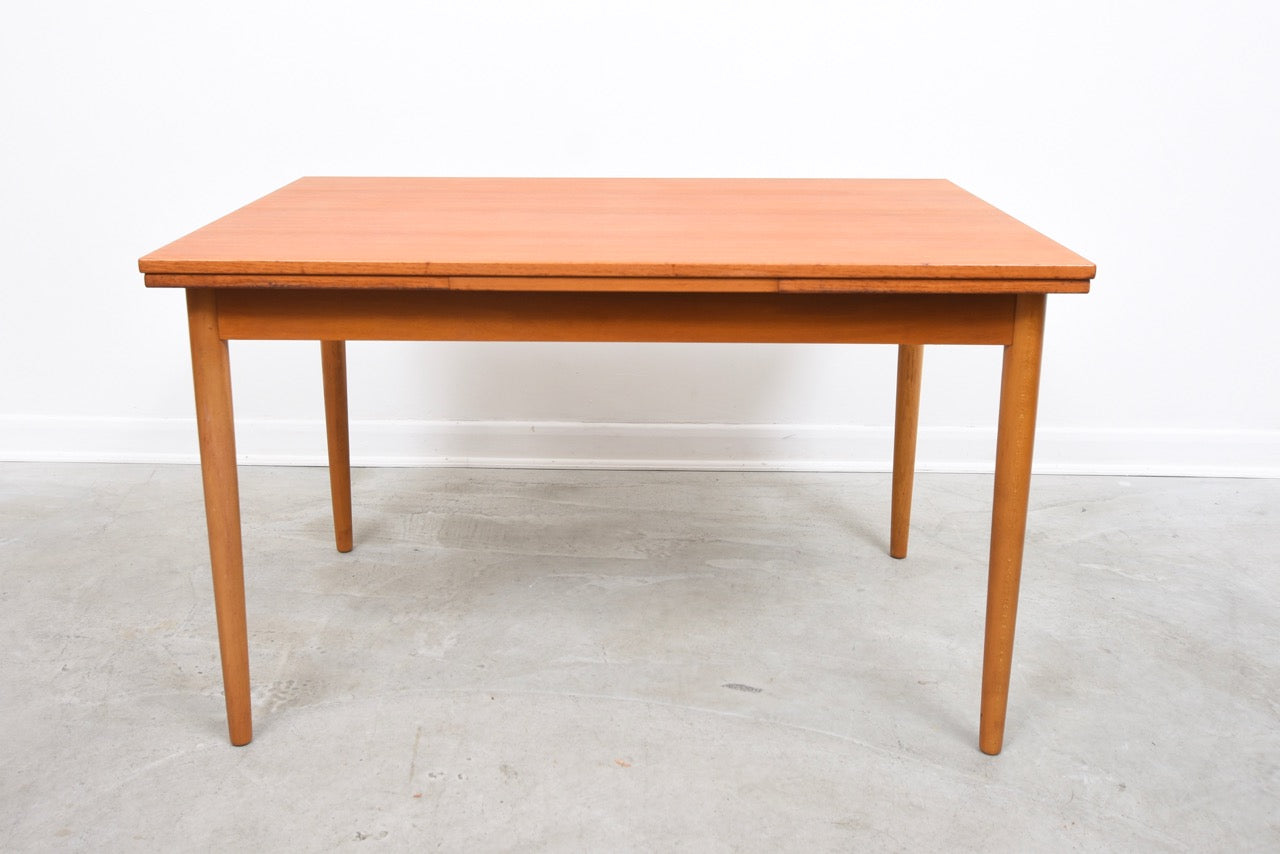 Extending rectangular dining table in teak