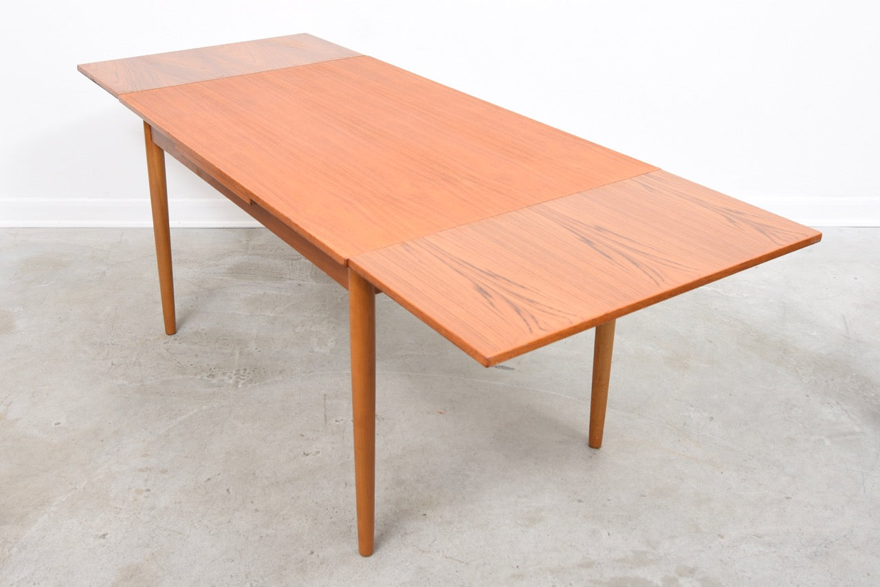 Extending rectangular dining table in teak