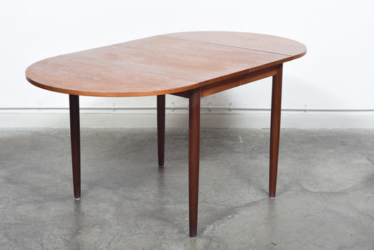 Extending square dining table in teak