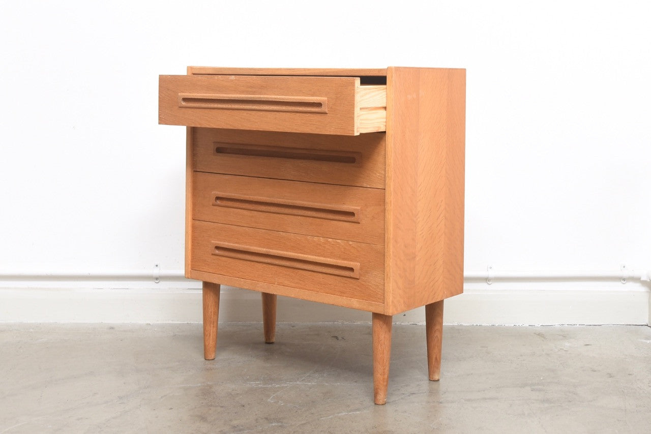 Low chest in oak with inset handles