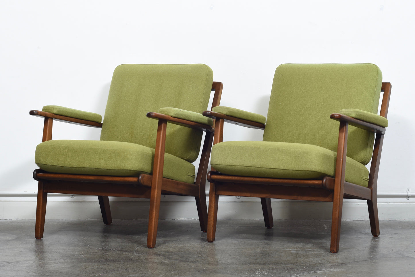 Two available: 1950s loungers with grass green wool cushions