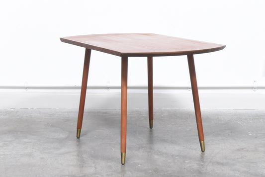 Teak table with brass-tipped legs