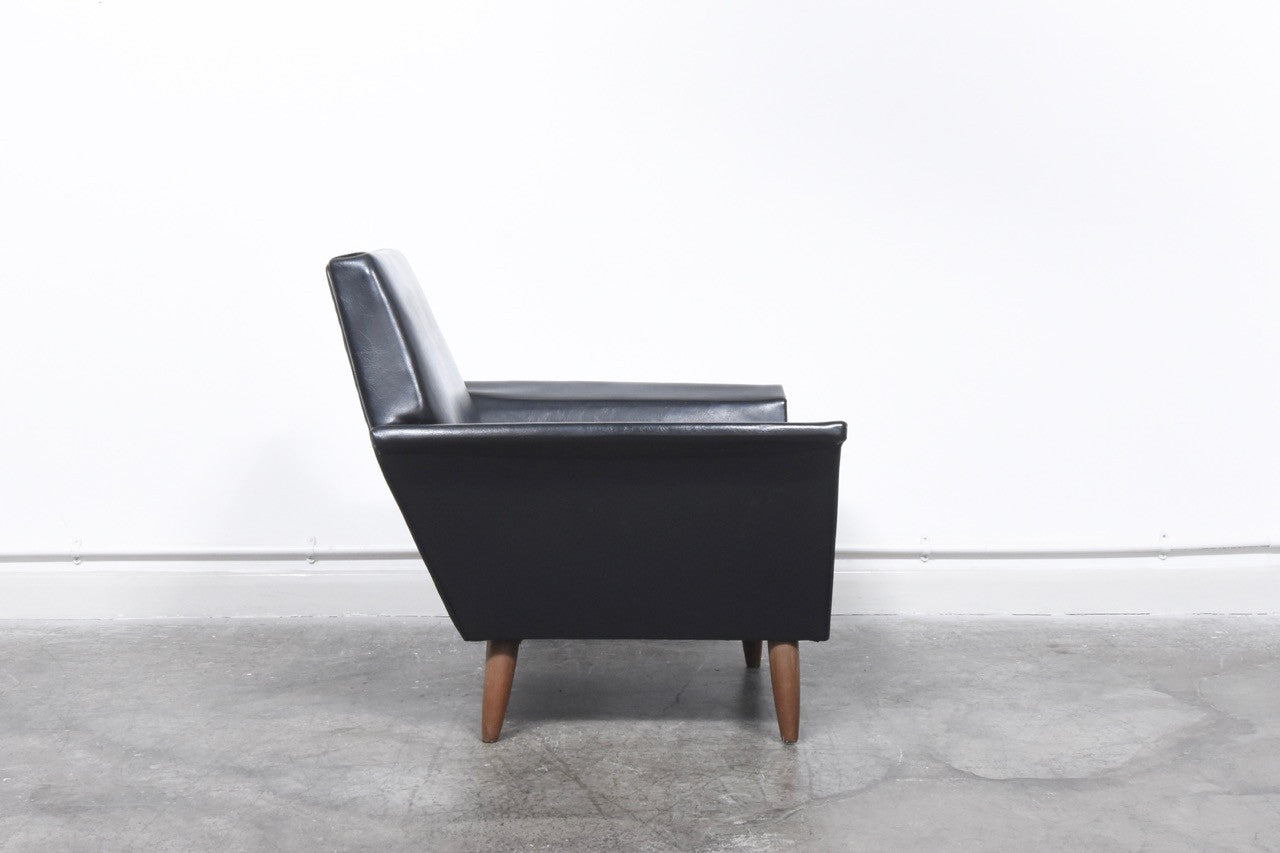 Black skai lounge chair on teak legs