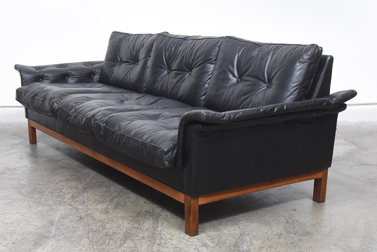 Black leather three seat sofa