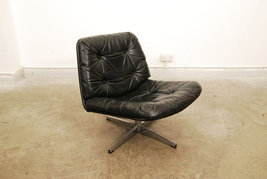 Low leather lounger on swivel base