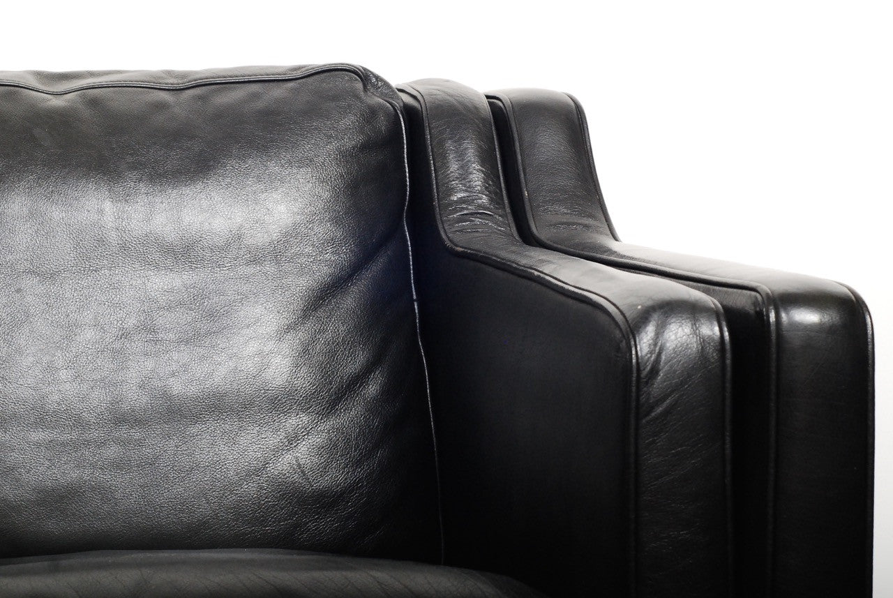 Two seat black leather sofa