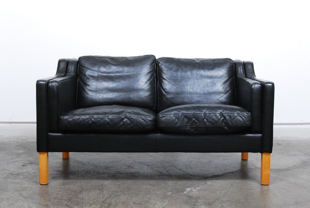 Two seat black leather sofa