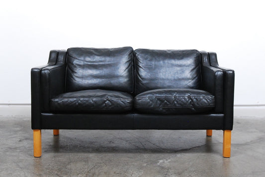 Two seat black leather sofa