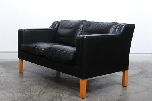 Two seat black leather sofa