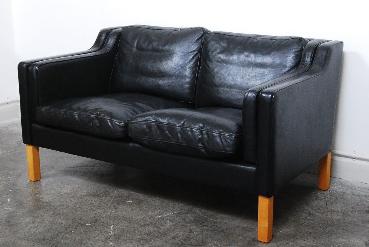 Two seat black leather sofa