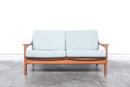 Teak-framed two seat sofa
