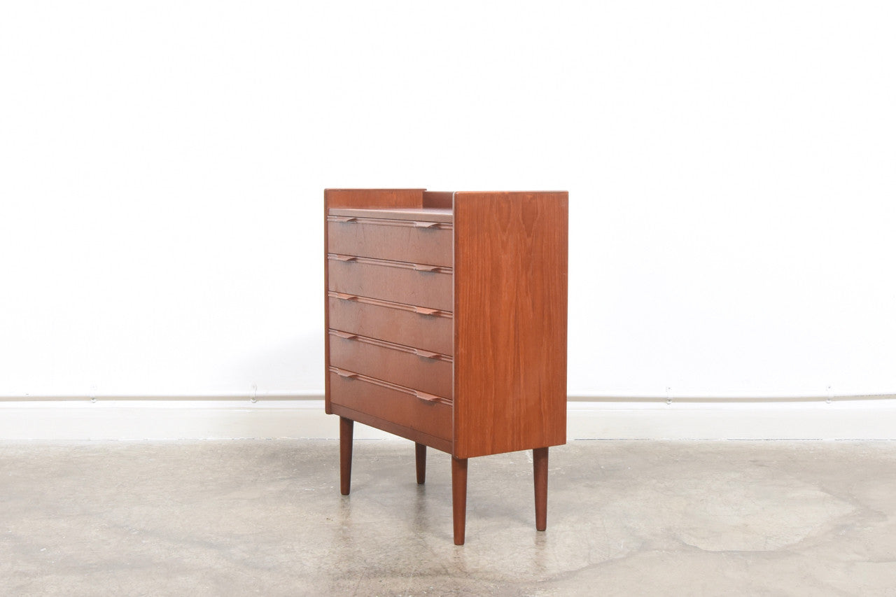 Short chest of teak drawers with lipped handles