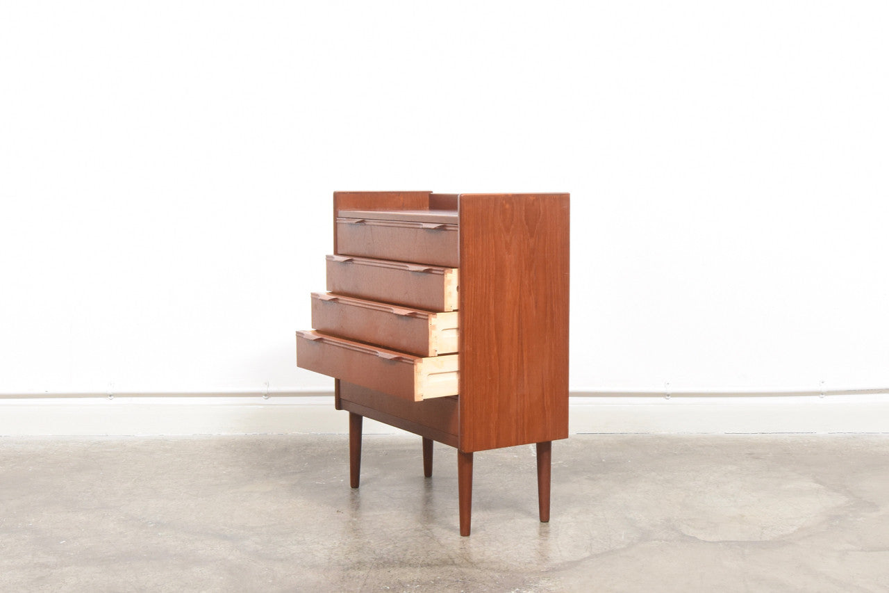 Short chest of teak drawers with lipped handles