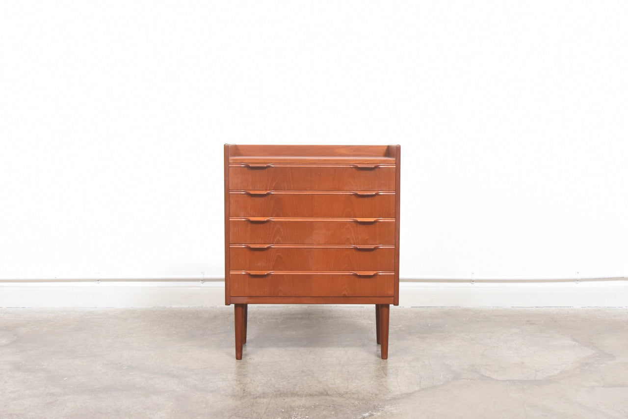 Short chest of teak drawers with lipped handles