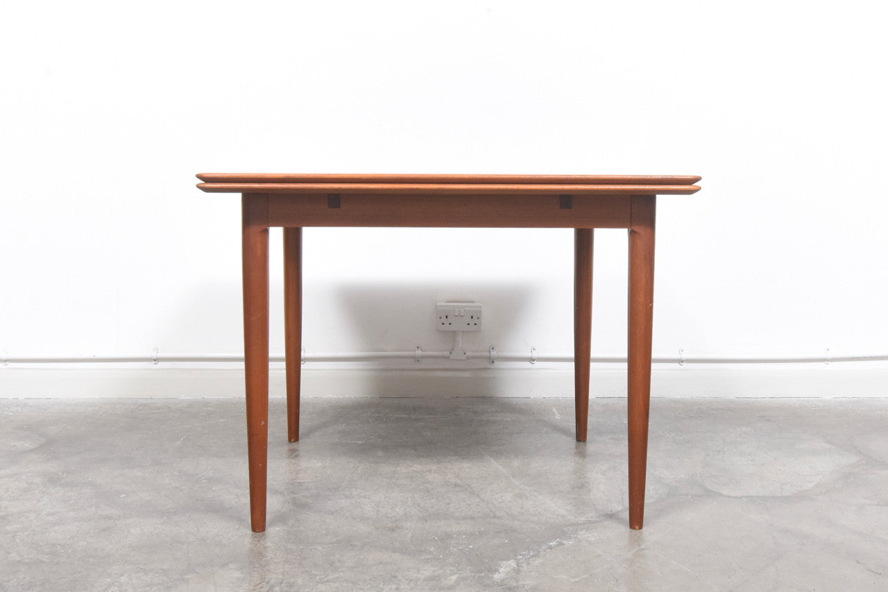 Extending square dining table in teak