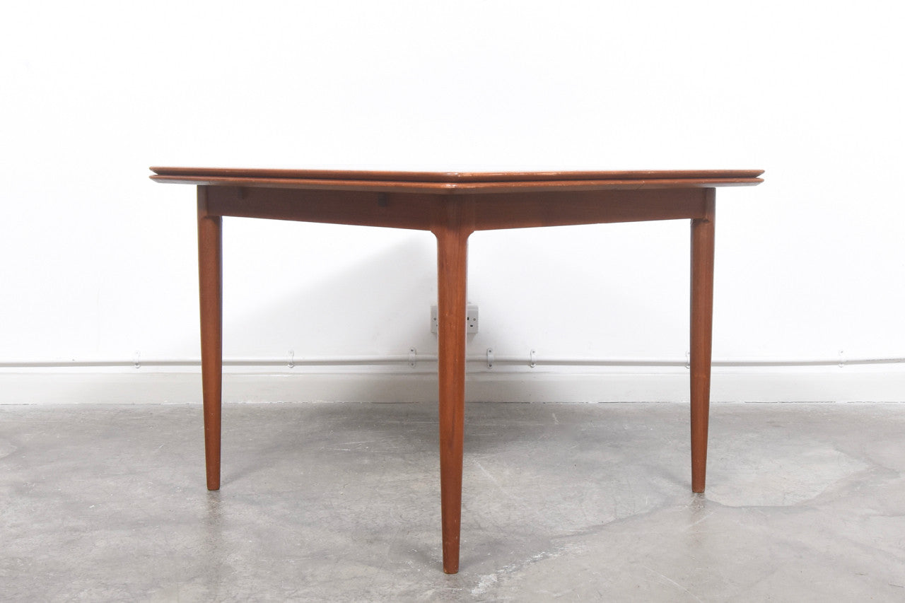 Extending square dining table in teak