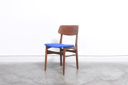Set of four dining chairs in teak with royal blue seats