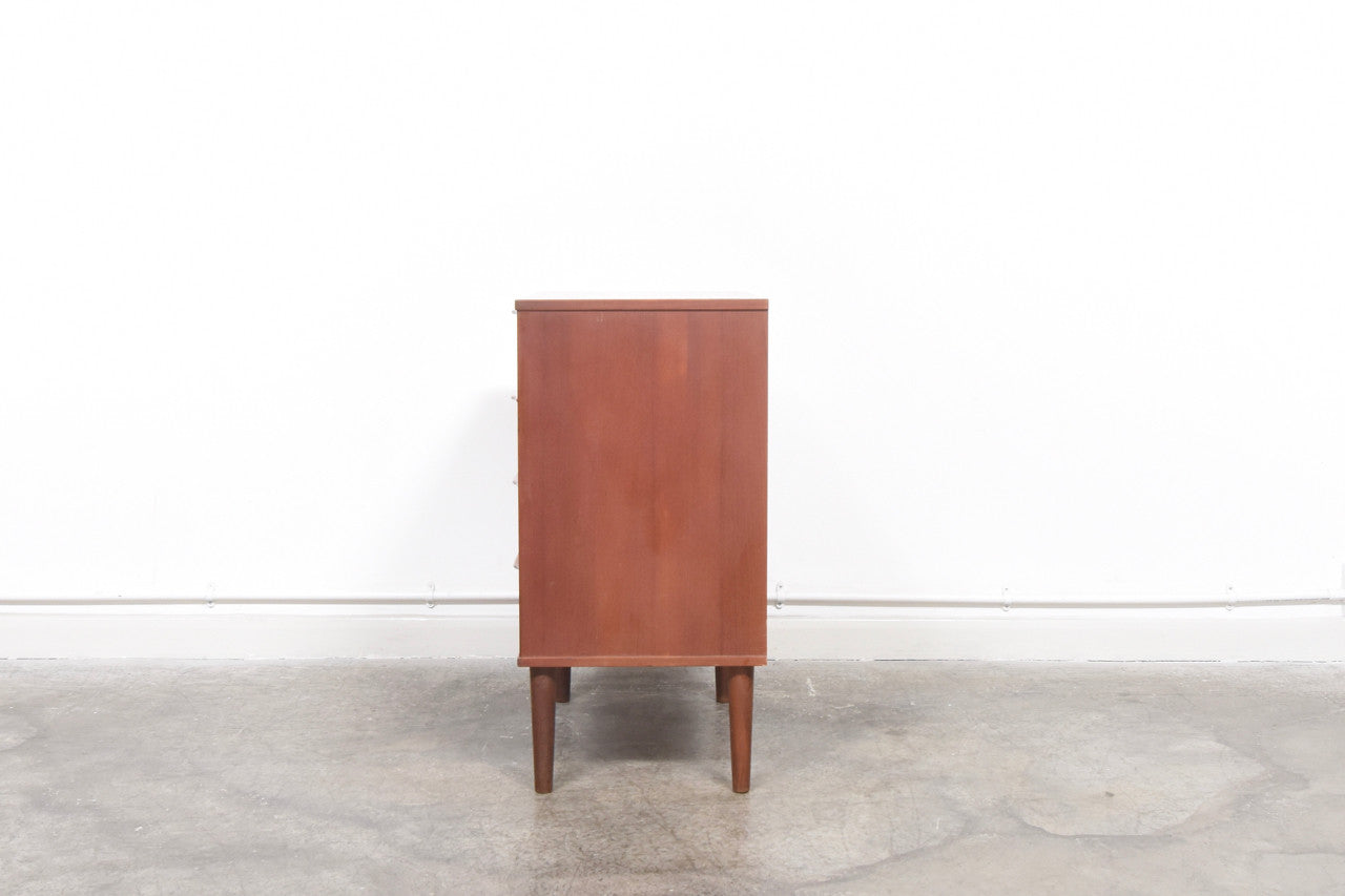 Chest of four drawers with lipped handles